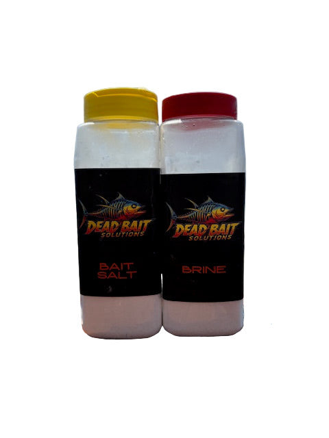 Two bottles of Dead Rattail Bait Salt on a wooden surface with a blue sky background.